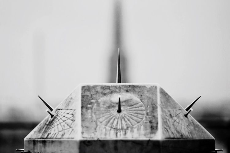 Close-up of clock against built structure