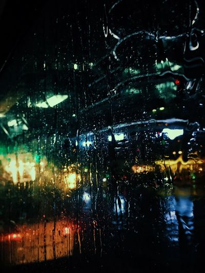 Close-up of wet window at night
