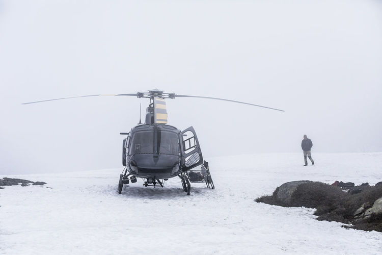 Helicopter pilot waits for improved visibility as weather changes.