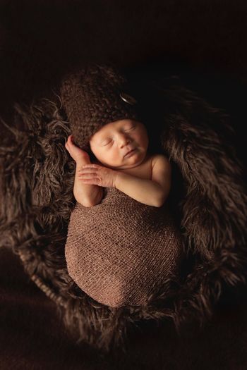 Directly above view of baby boy wrapped in jute