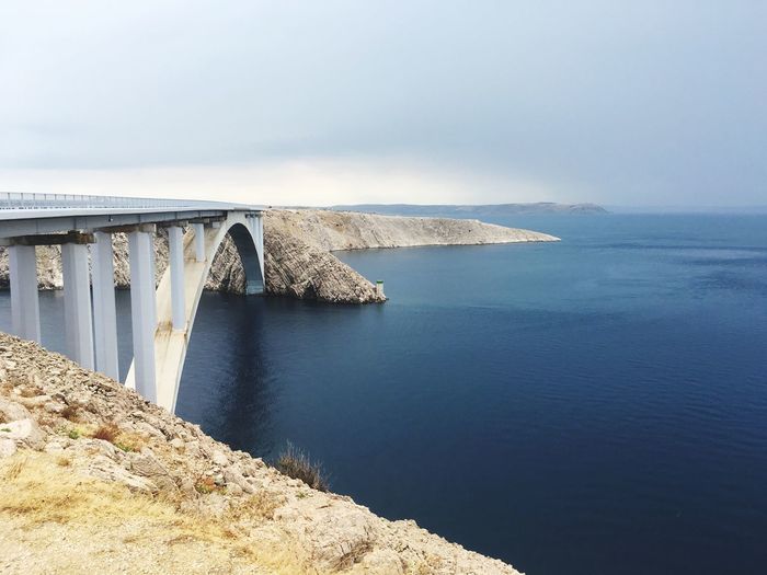 Paski most bridge over sea against sky