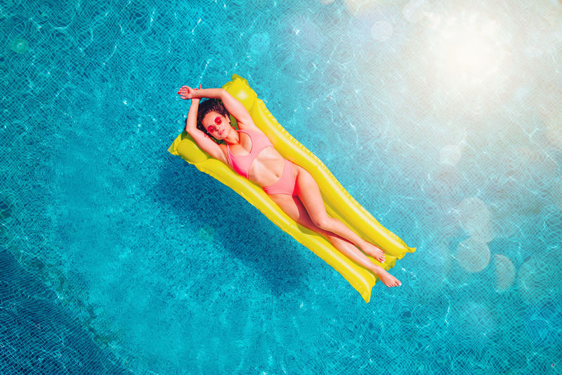 High angle view of person floating on swimming pool