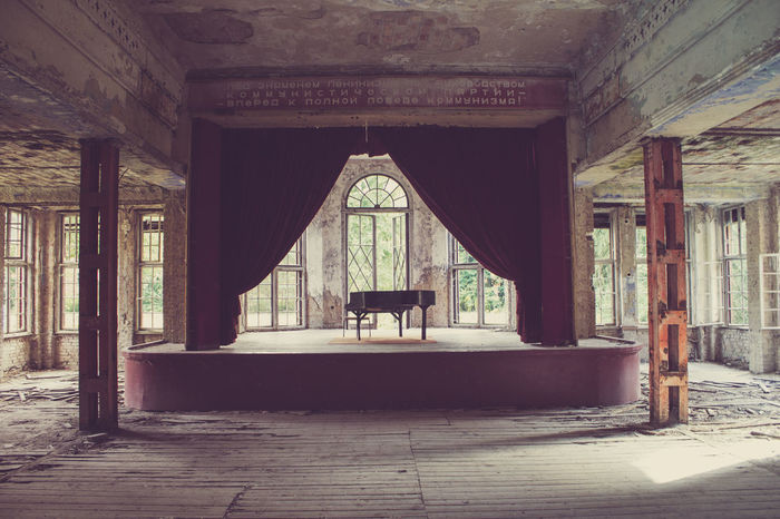Piano on stage in abandoned theater
