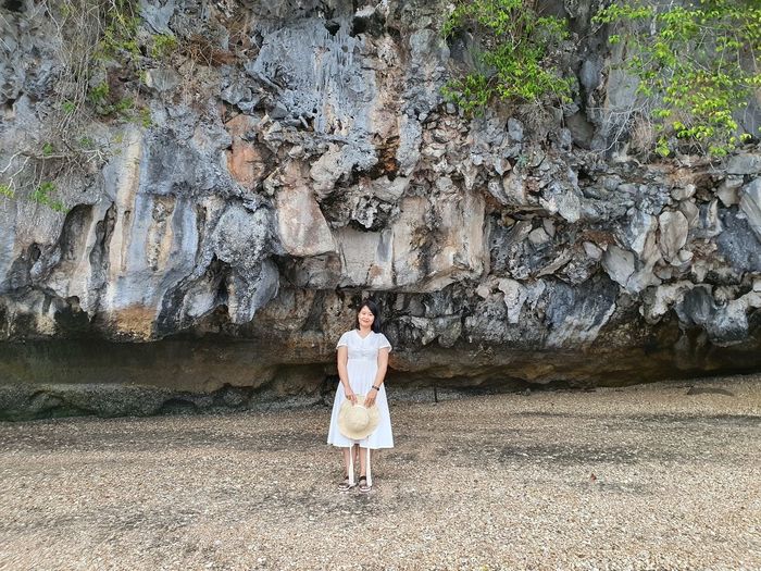 Rear view of woman standing on rock