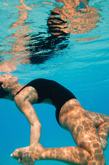 Female model swimming in pool