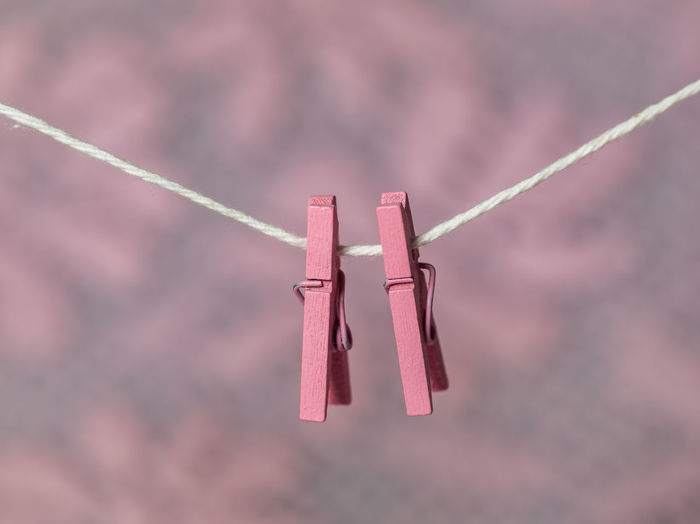 Low angle view of clothespins hanging on rope