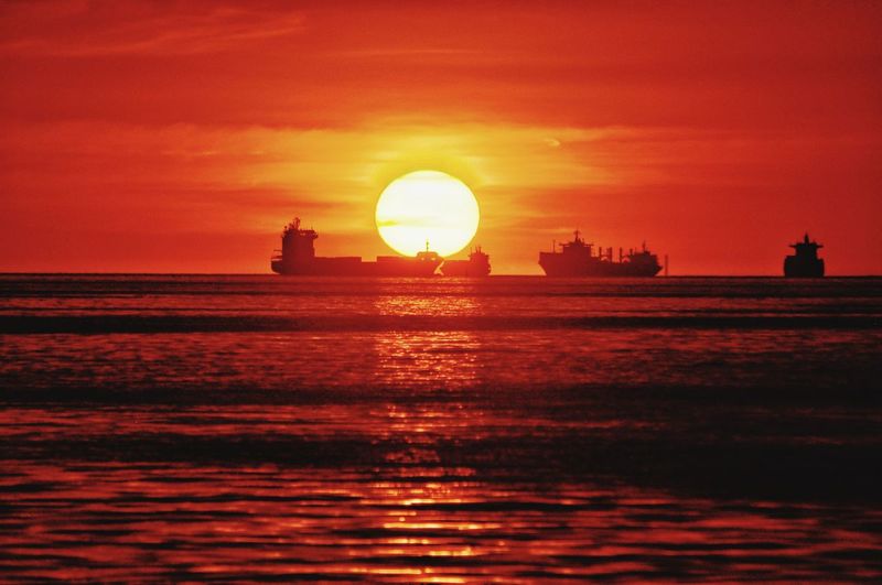 Scenic view of sea against orange sky