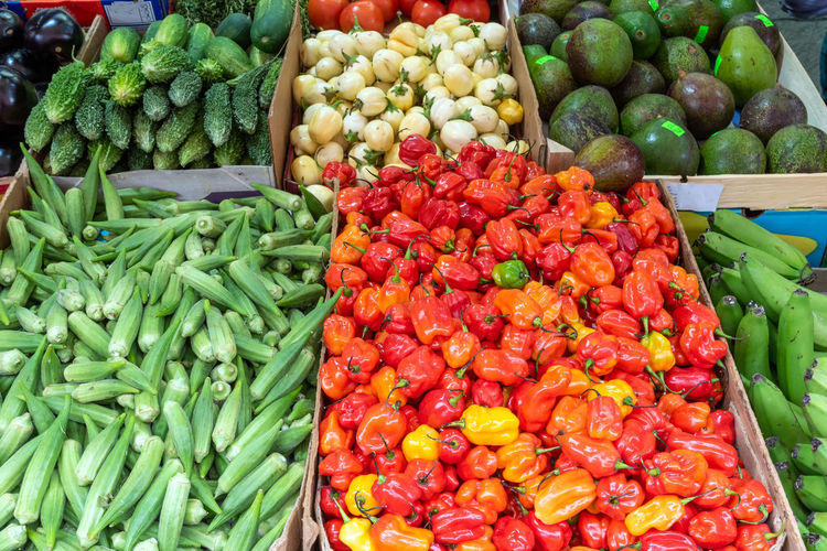 Mini bell peppers, pickles and peas for sale at a market
