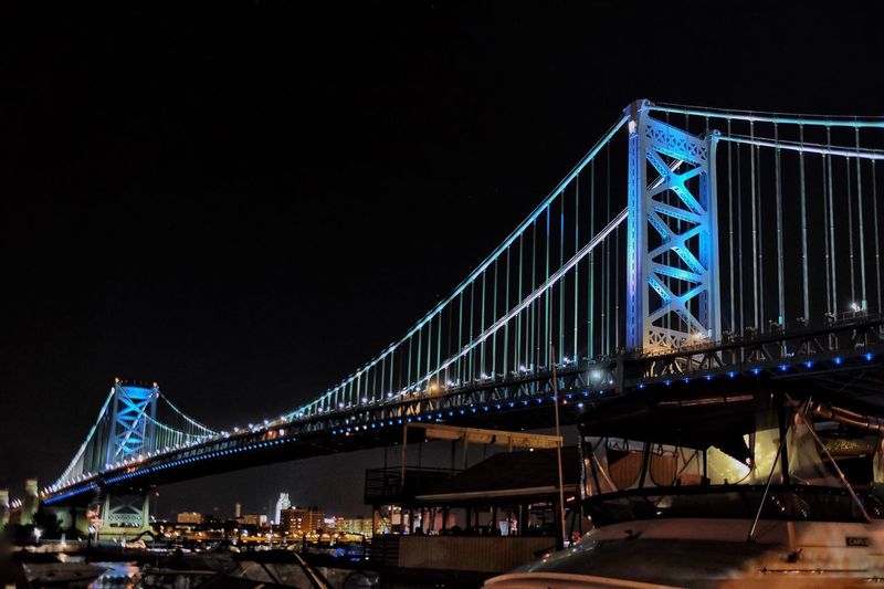 Low angle view of brooklyn bridge against sky at night
