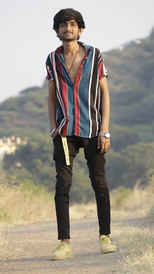 Portrait of young man standing on land