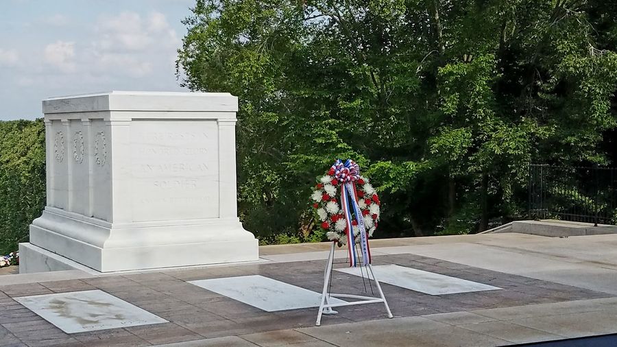 Wreath in front of tombstone at cemetery