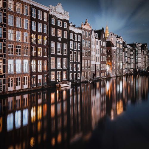 Reflection of building in canal at night
