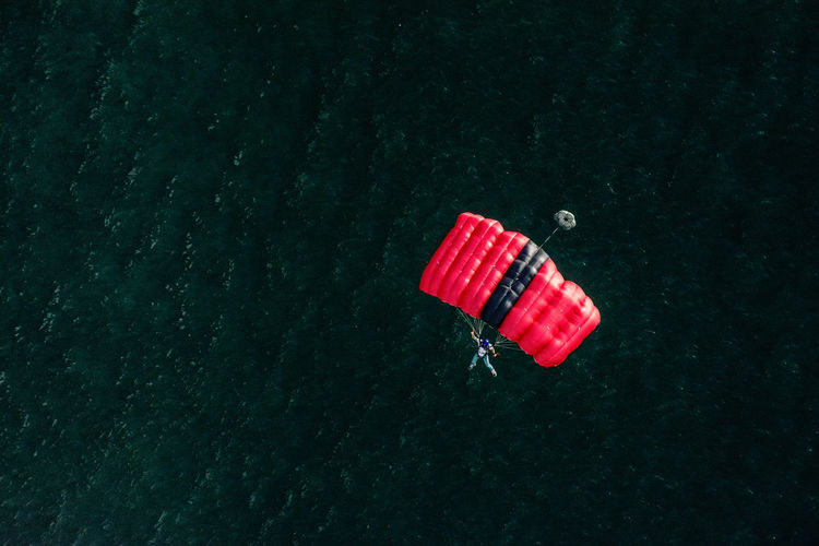 High angle view of man paragliding over sea