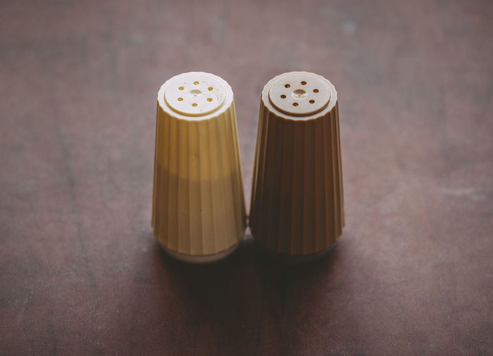 Close-up of salt and pepper shakers on table