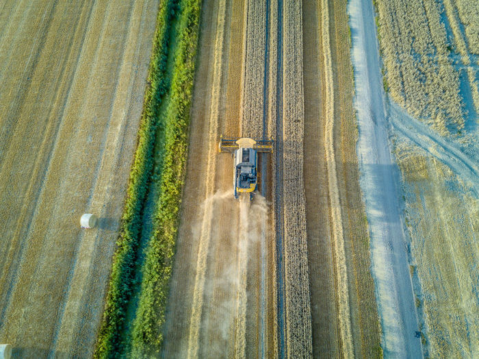 Aerial view of combine harvester harvesting at farm