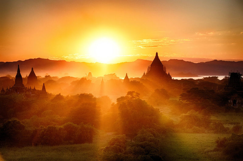 Temples against sky during sunset