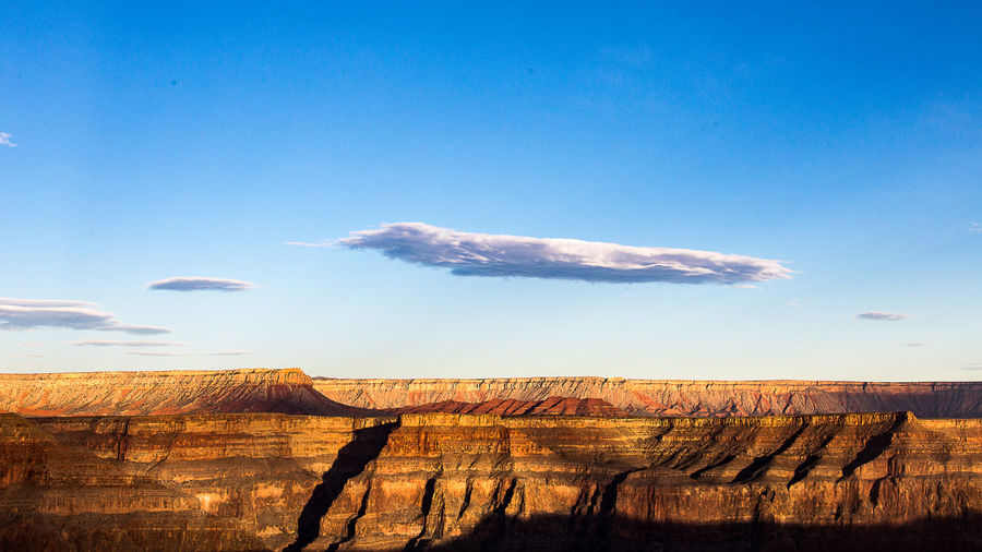 Scenic view of landscape against blue sky