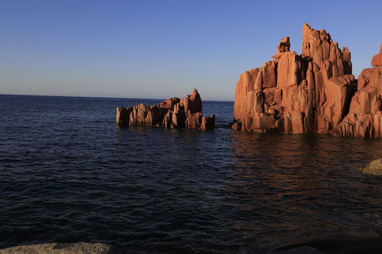Panoramic view of rocks in sea against clear sky