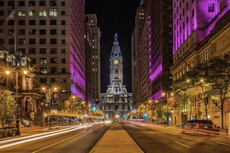 Diminishing view of illuminated street against philadelphia city hall at night