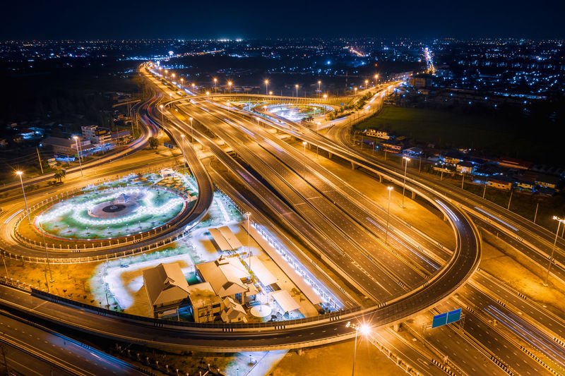 Aerial view of light trails on elevated road at night