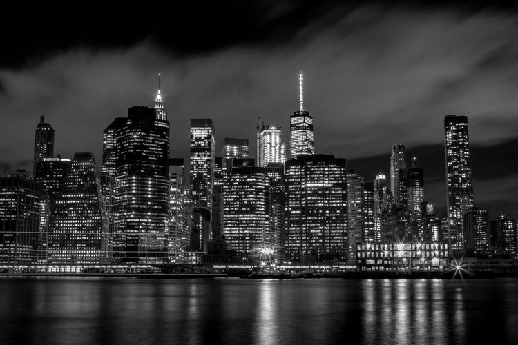 Illuminated new york cityscape against sky at night