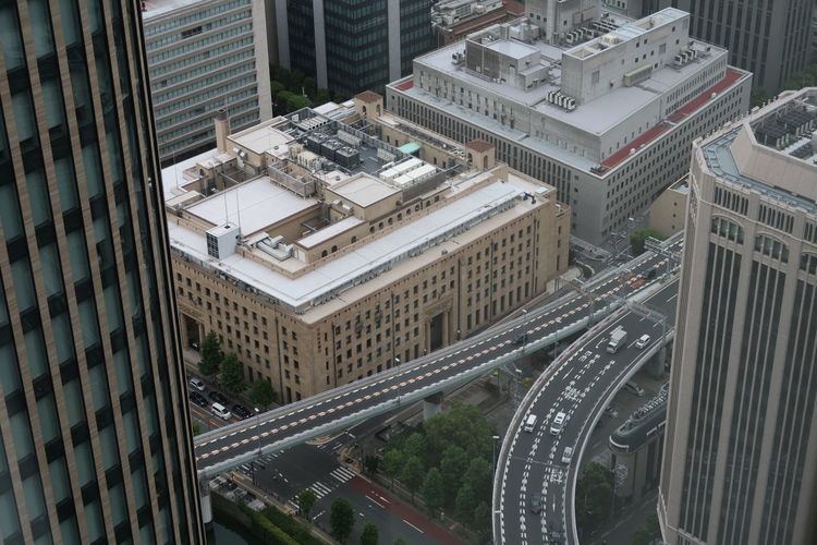 Aerial view of elevated road amidst buildings in city