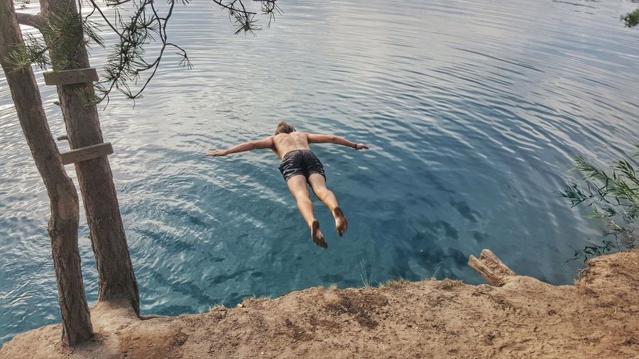 Man jumping into lake