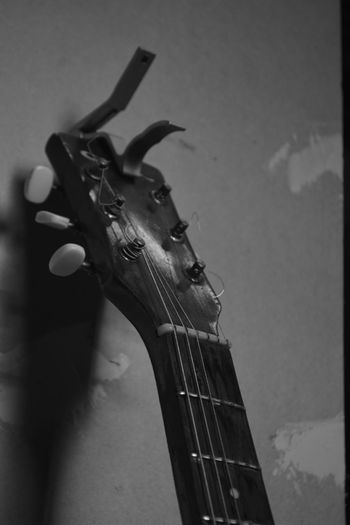 Close-up of guitar against wall