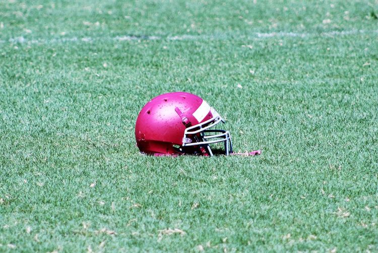 Red football helmet on field