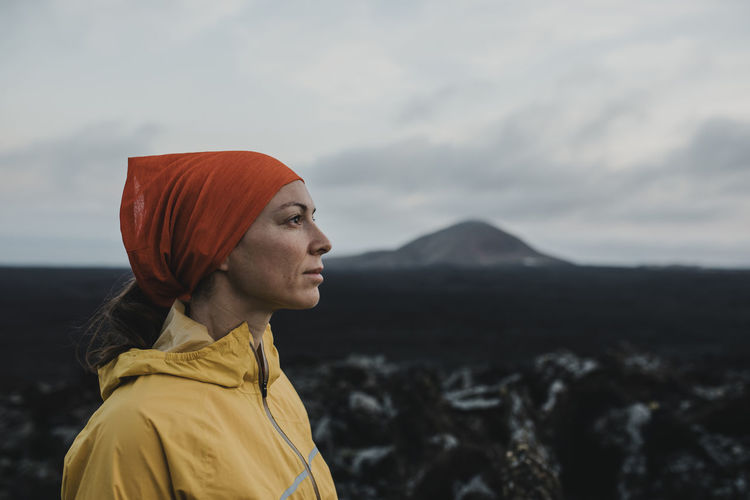 Thoughtful woman wearing bandana at caldera blanca volcano, lanzarote, canary islands, spain