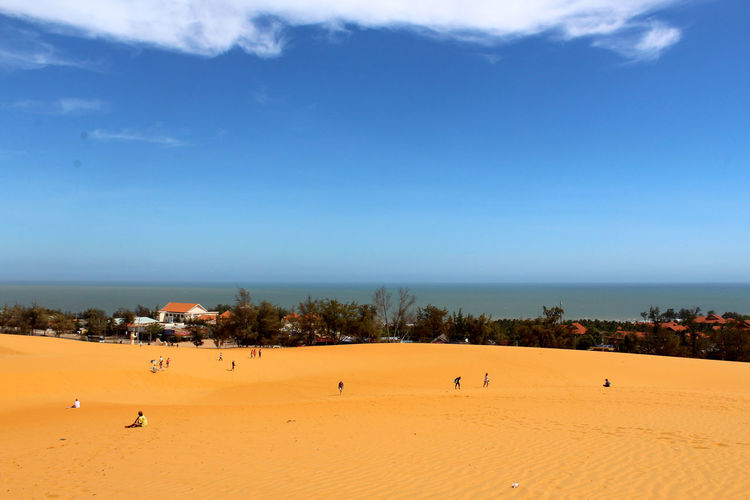 Scenic view of sandy beach against sky