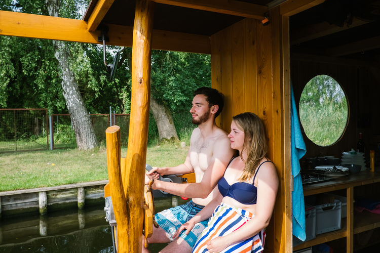 Couple sitting in boat over lake