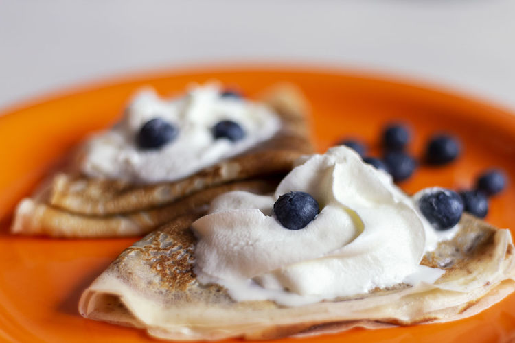 Delicious homemade pancakes with fruits and blur background on the table