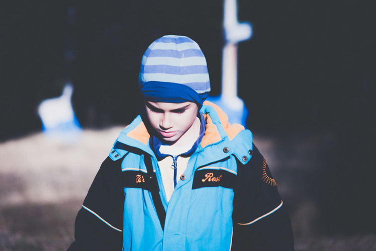 Boy wearing warm clothing on field