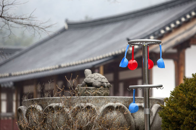 Plastic ladles hanging against house