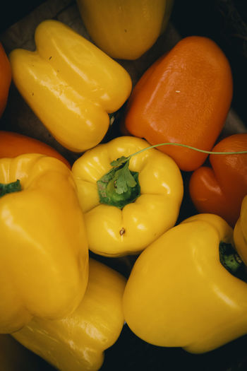 Top down photo of yellow and orange peppers.