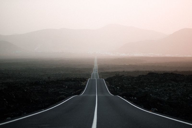 Road amidst landscape against sky
