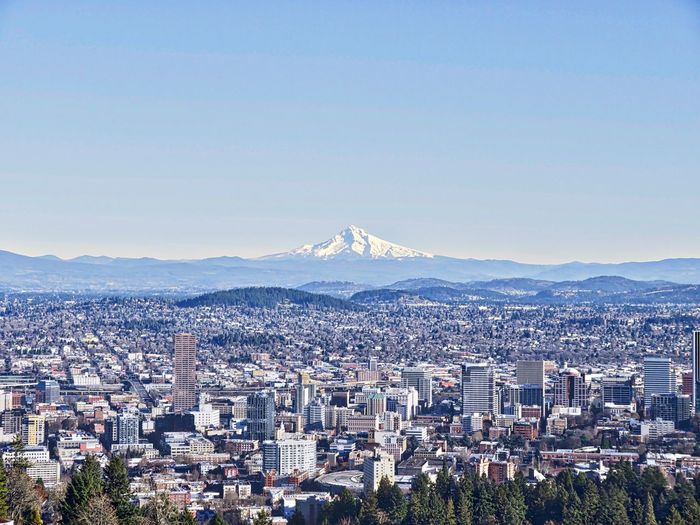 View of cityscape against blue sky