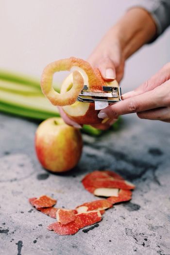 Close-up of hand peeling apple