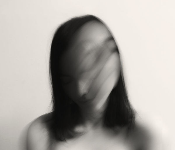 Portrait of woman against white background