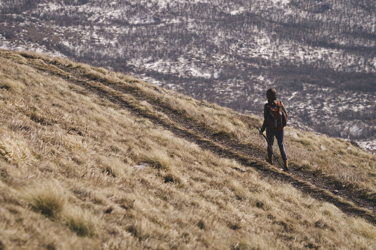 Rear view of person hiking on rtanj mountain