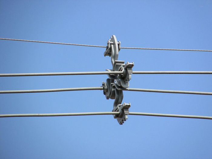 Low angle view of cables against clear blue sky