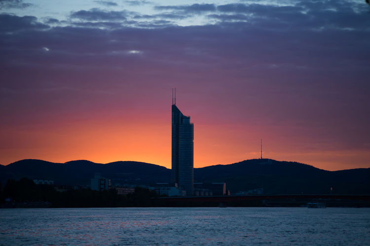 Silhouette of buildings against sky during sunset