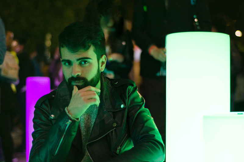 Portrait of bearded young man wearing leather jacket in nightclub