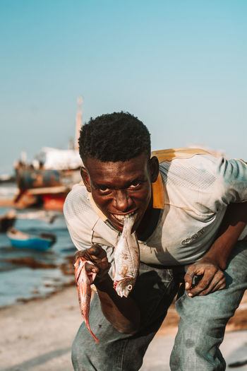 Portrait of young man holding fish