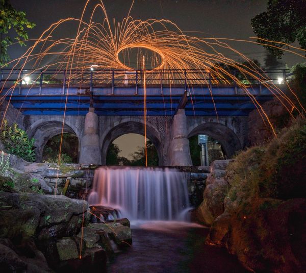 Burning a wirewool in the bridge over river at night