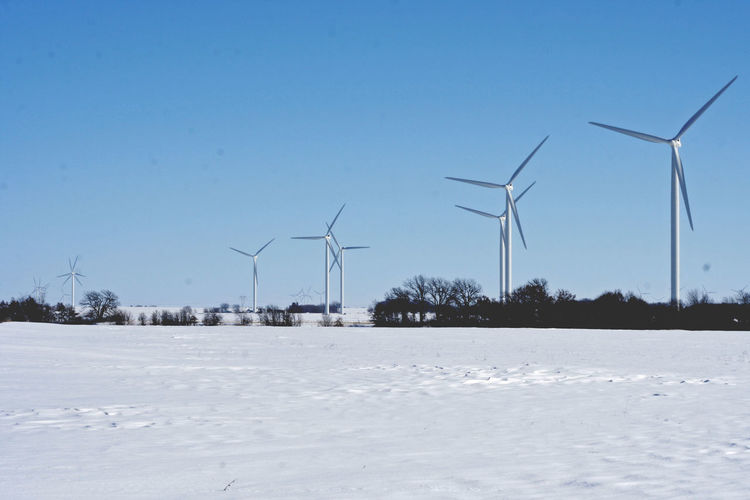 Wind turbines on snowy field