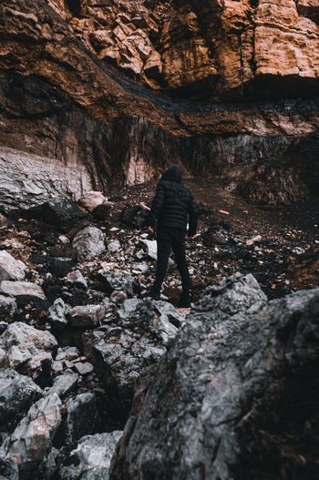 Rear view of man standing on rock
