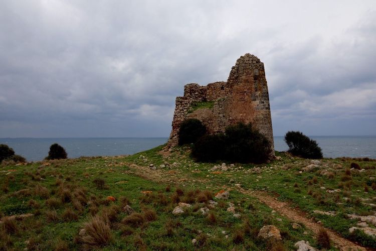 Castle by sea against sky