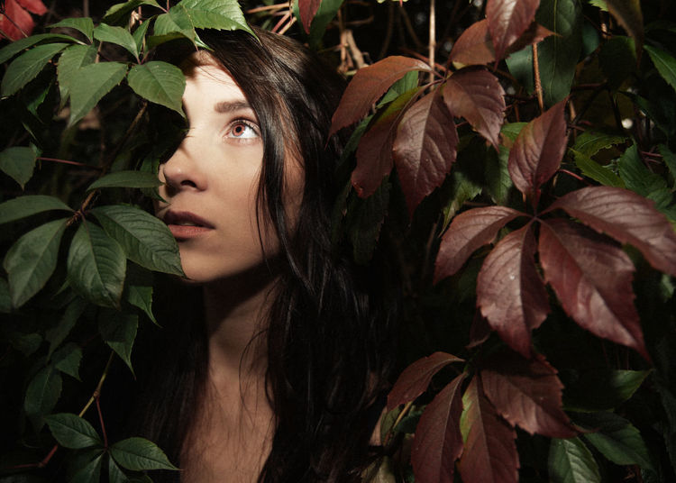 Close-up of young woman amidst plants